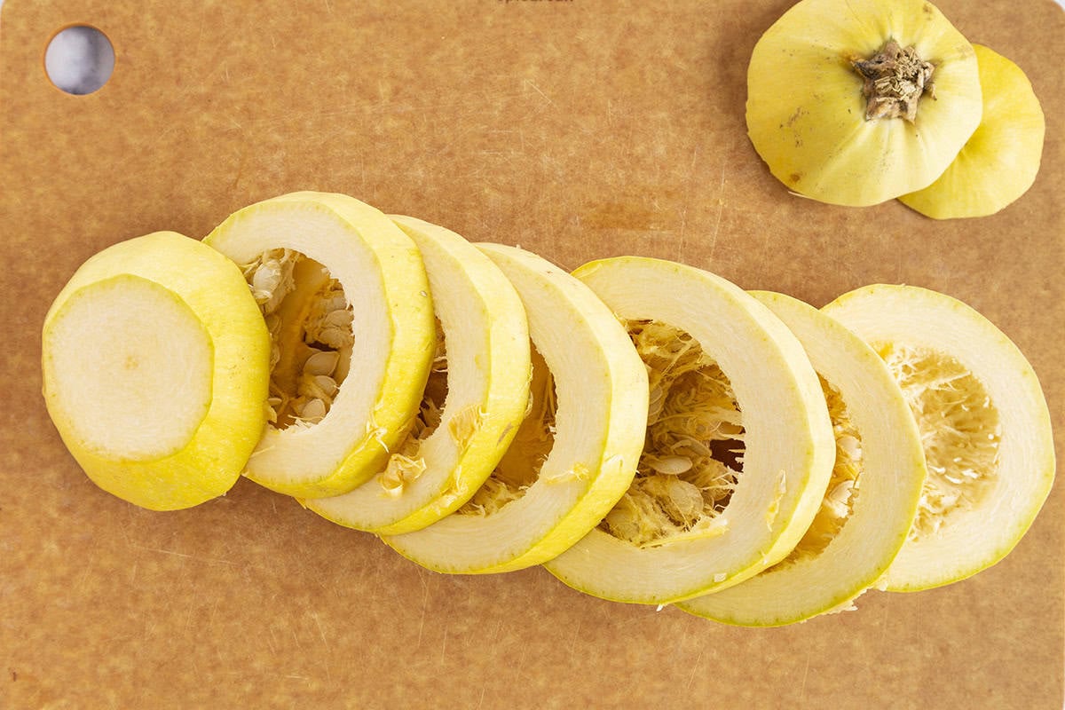 Cutting rings on spaghetti squash on cutting board. 