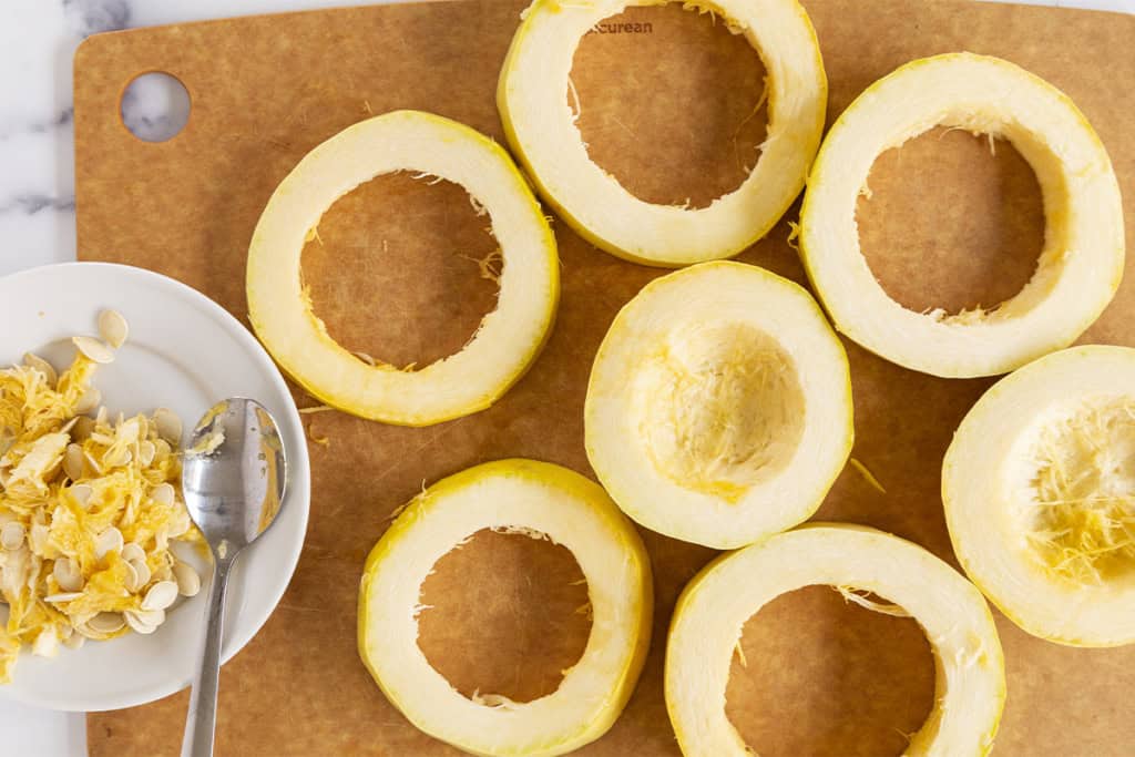 Cutting rings on spaghetti squash on cutting board.