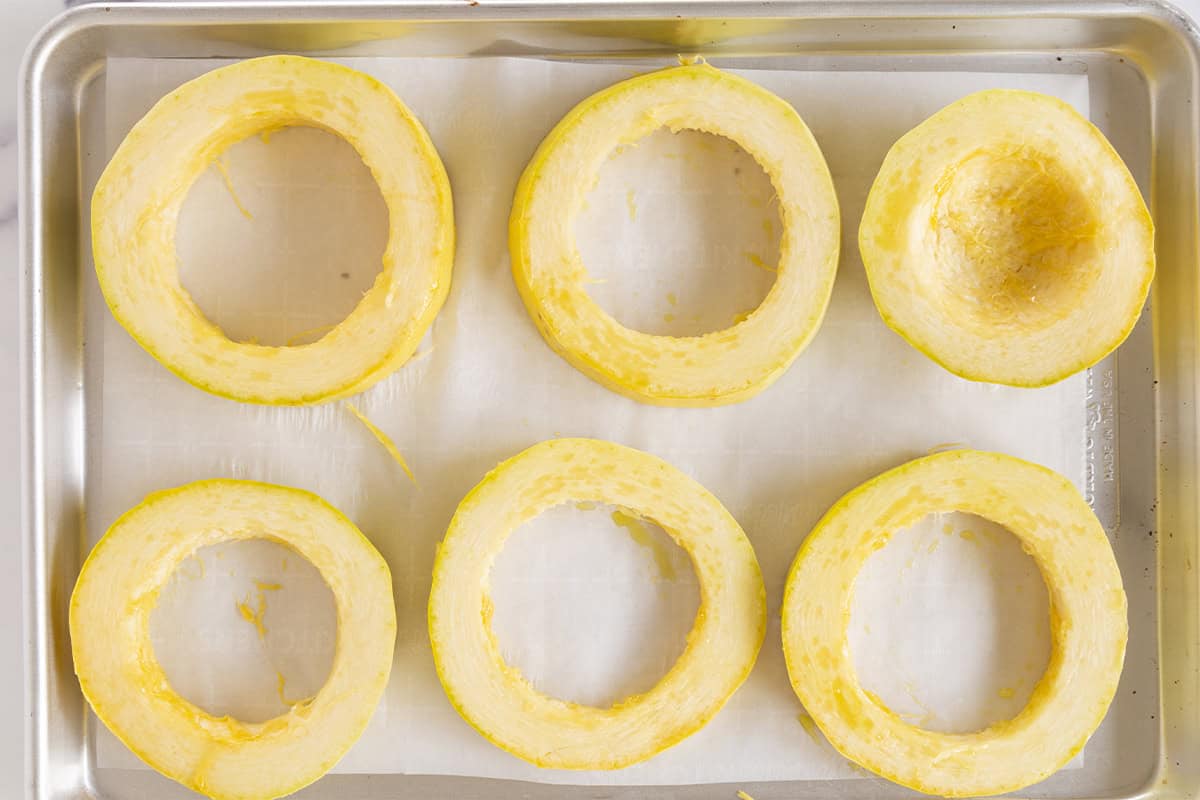 Rings on spaghetti squash on baking sheet.