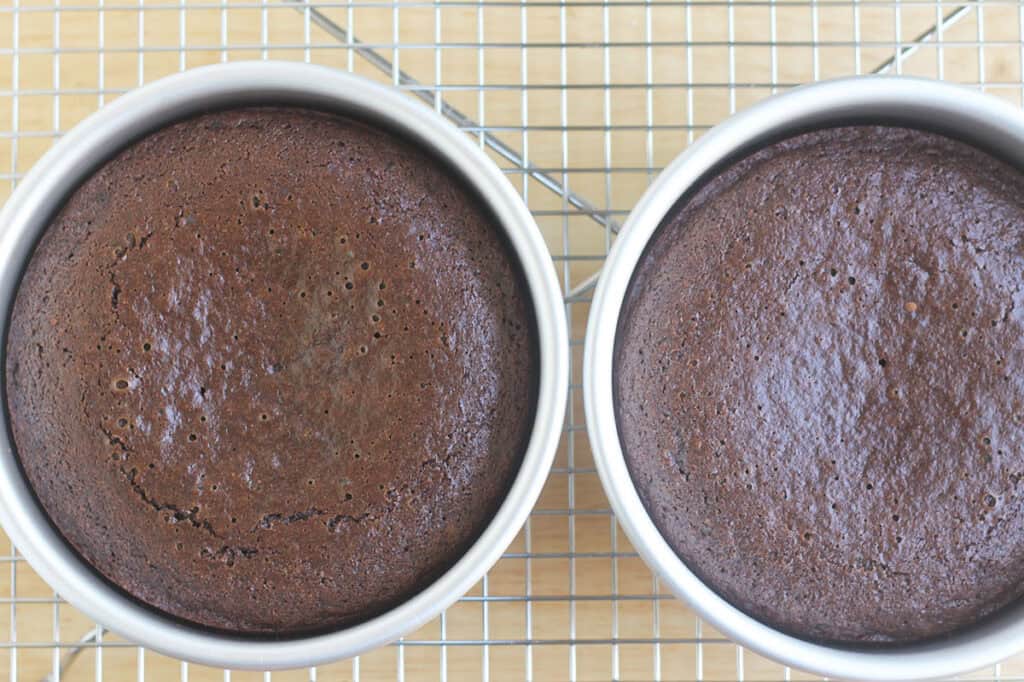 baked chocolate cake in pans on wire rack.