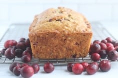 baked cranberry bread loaf on rack.