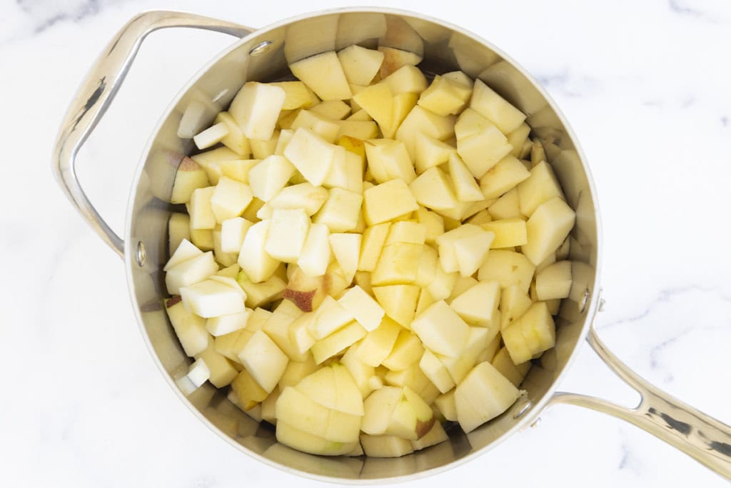 Diced apples in pot for cinnamon applesauce.