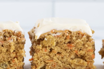 Carrot cake bars in a row on countertop.