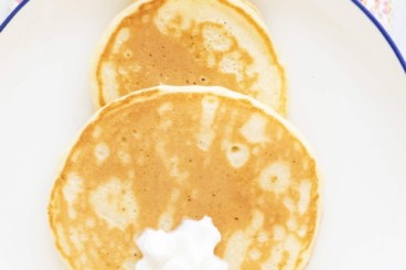 Easter bunny pancake on plate with fruit sides.