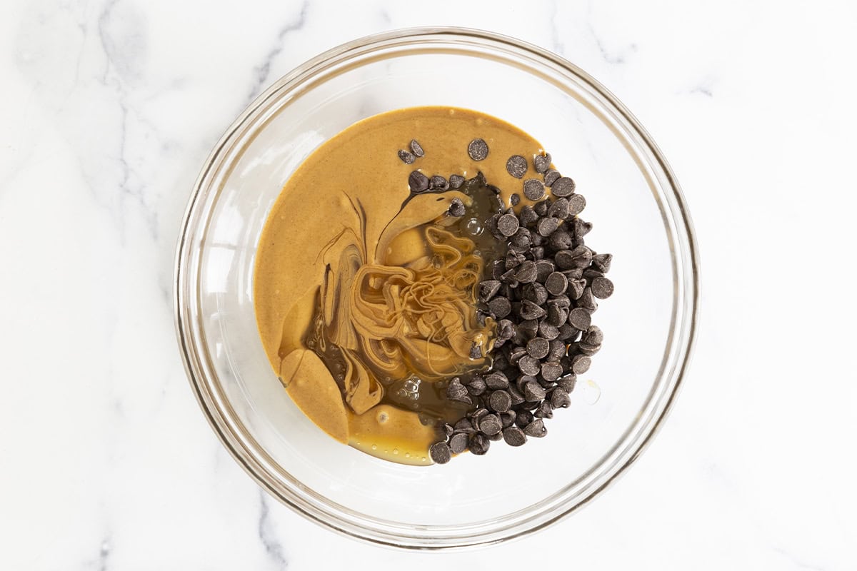 Peanut butter and chocolate chips in glass bowl. 