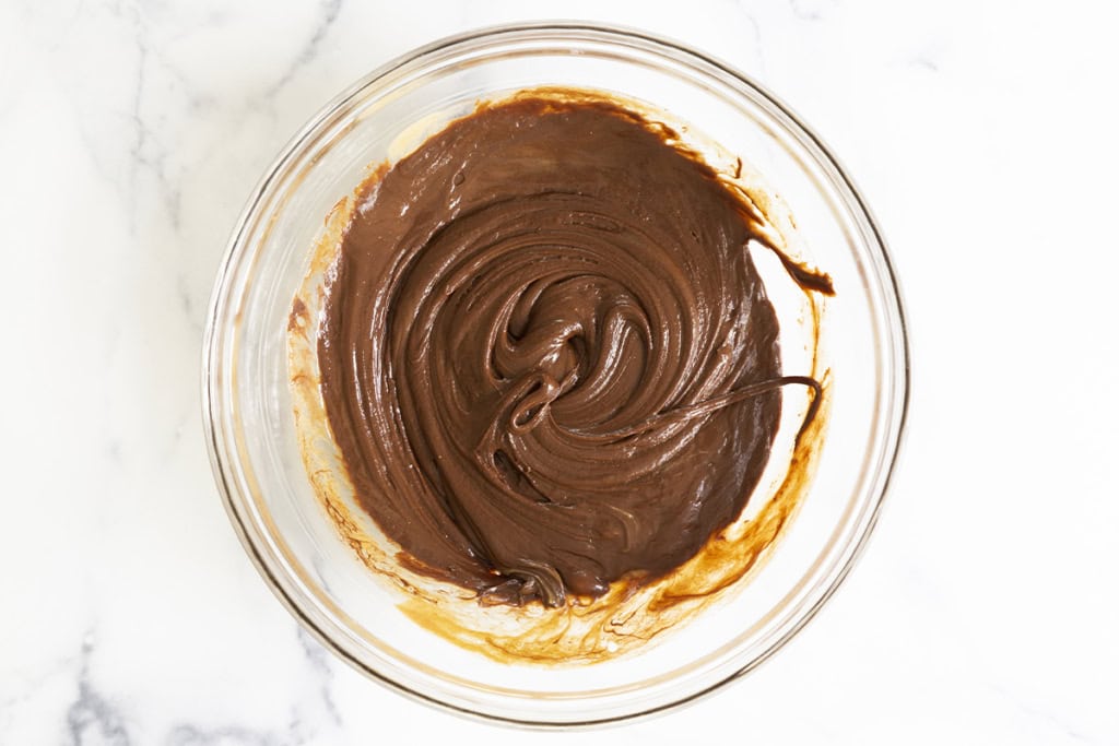 Melted chocolate in glass bowl for chocolate granola bars.