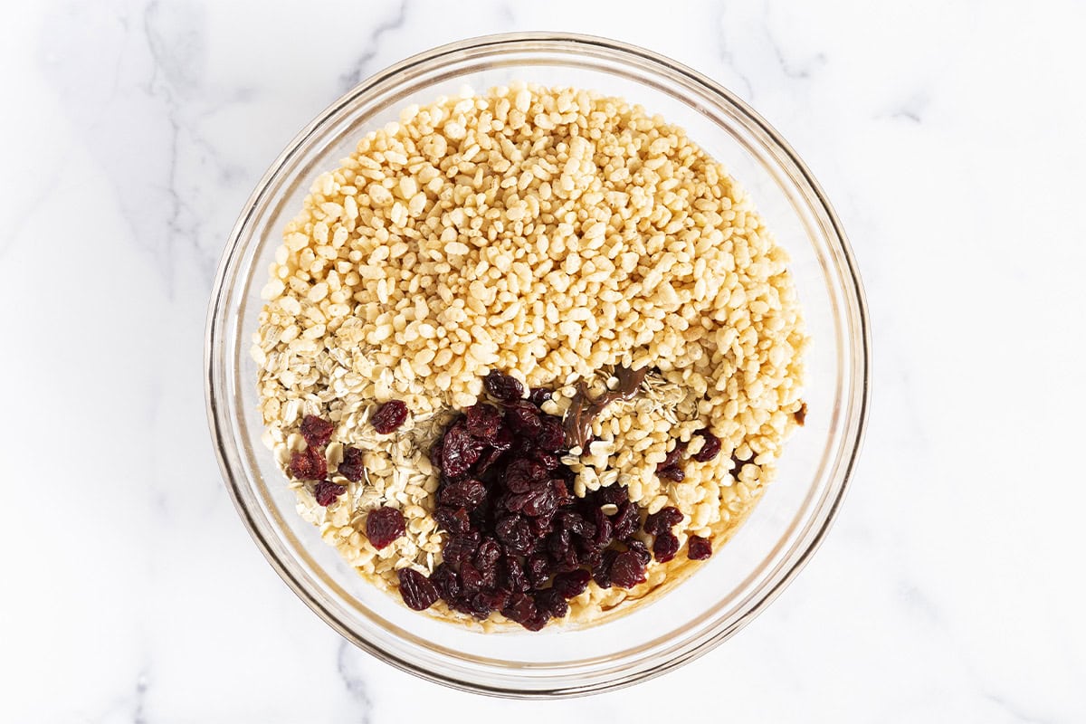 Ingredients for chocolate granola bars in glass bowl.