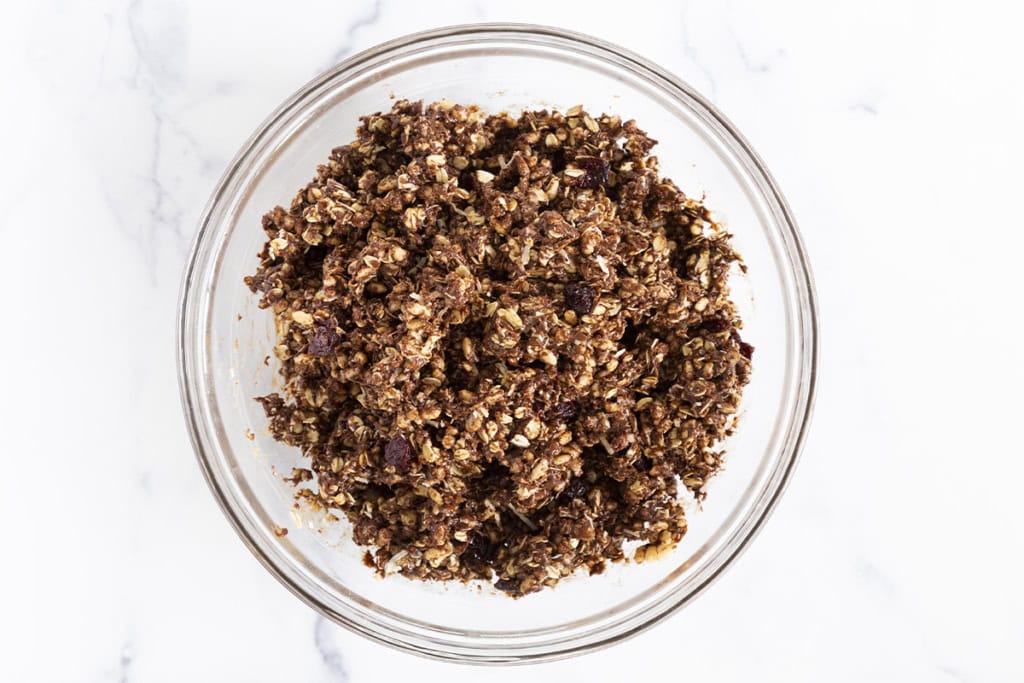 Chocolate granola bar dough in glass bowl.