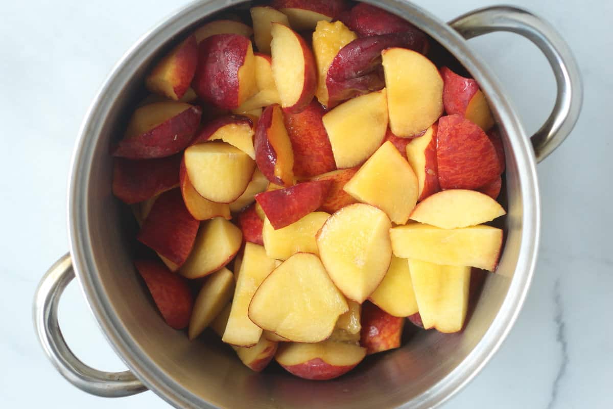 Peaches in pot for peach sauce. 