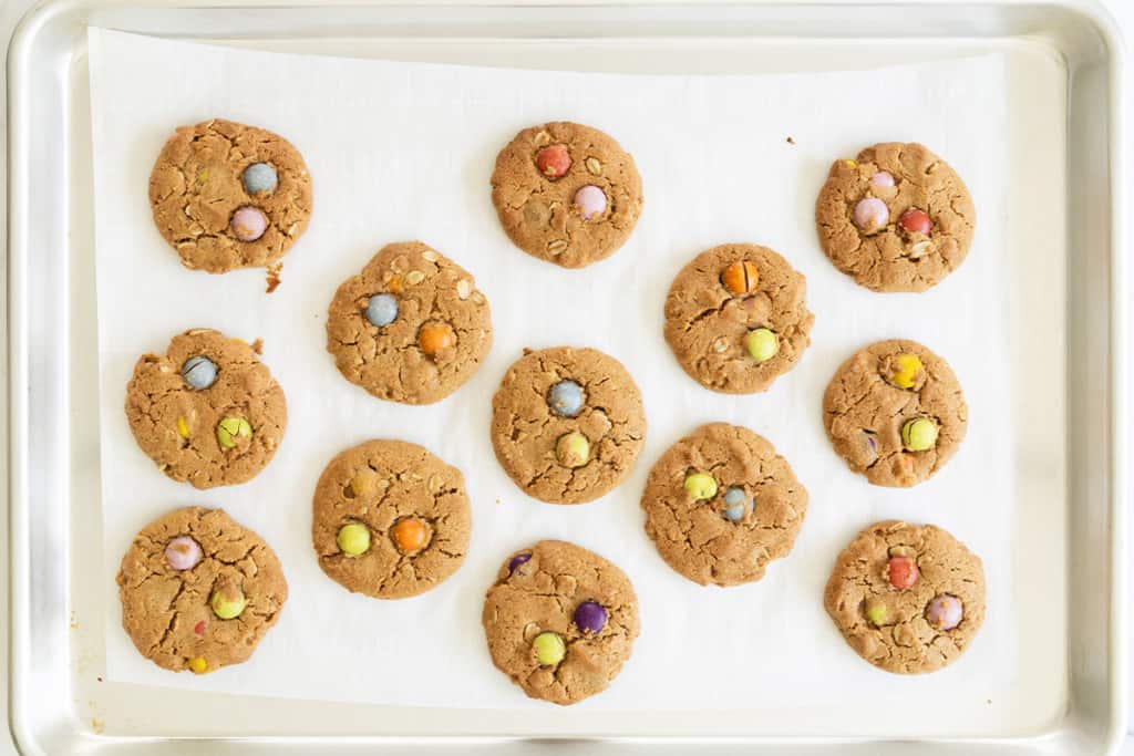 Monster cookies on cookie sheet after baking.