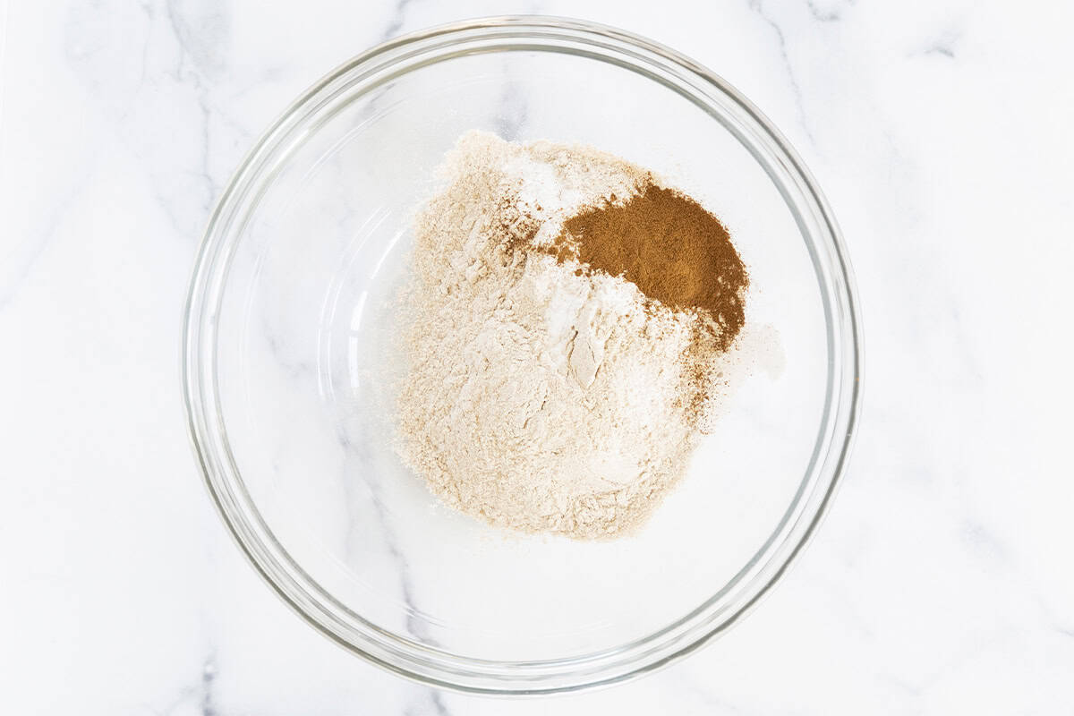 Dry ingredients in glass bowl for apple cinnamon muffins. 