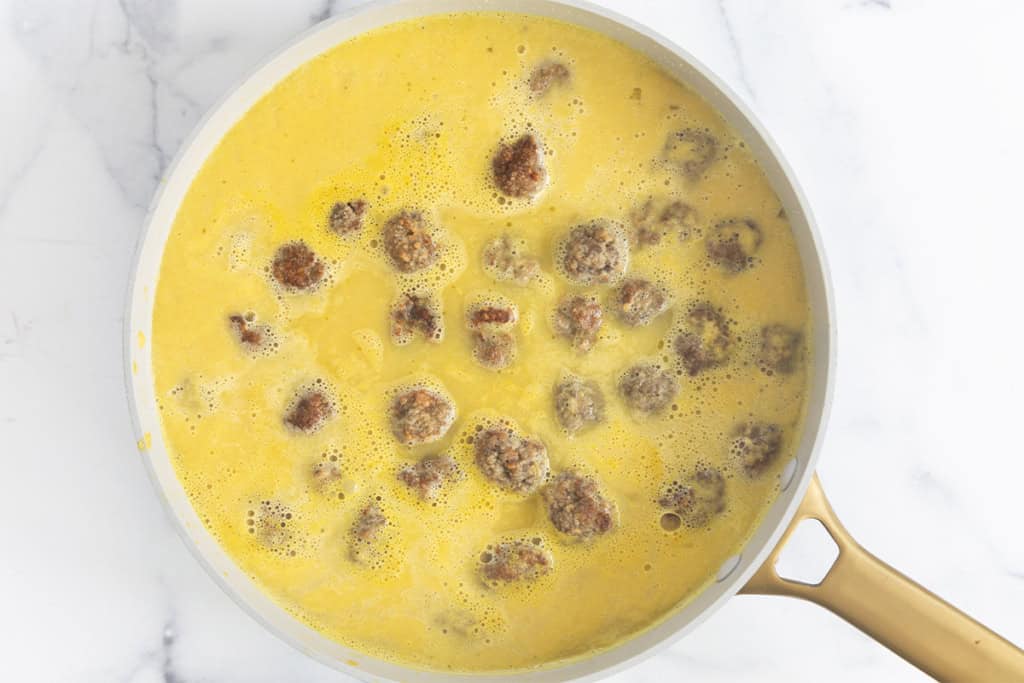 Meatballs and broth in pan for meatball soup.