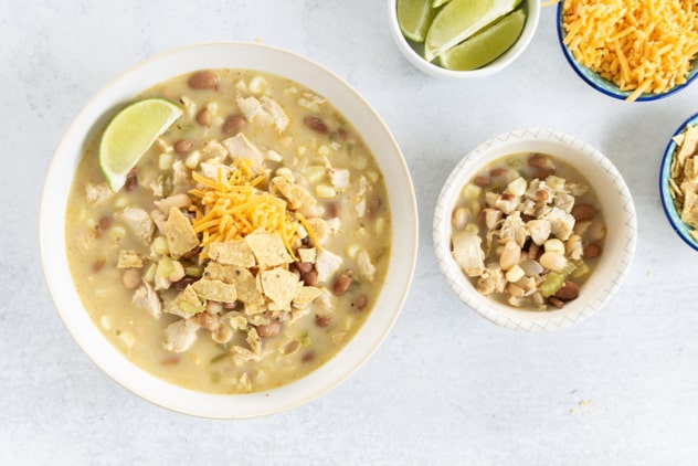 White turkey chili in two bowls with toppings.