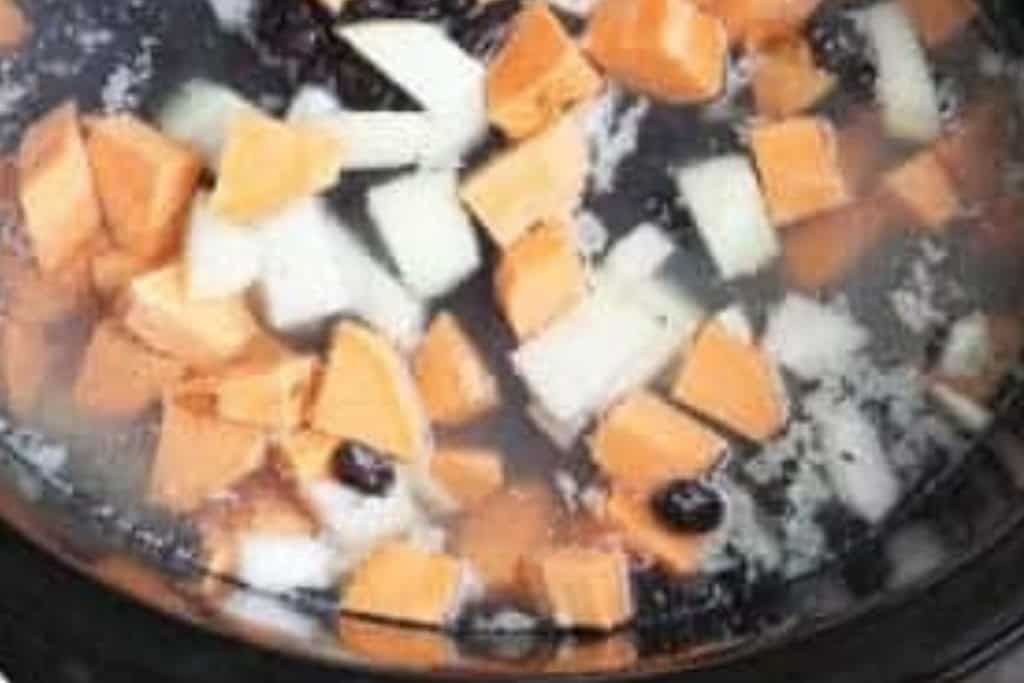 Veggies and beans in slow cooker for black bean soup.