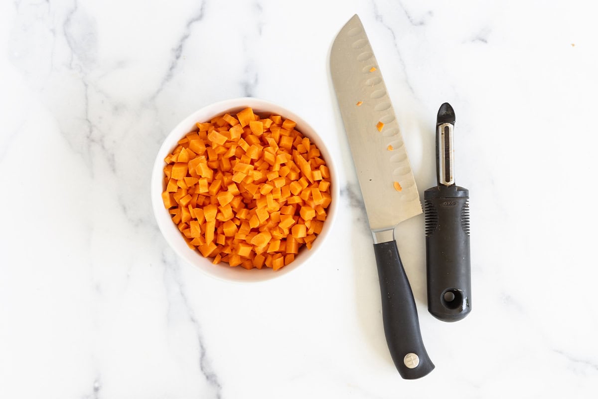 Chopped carrots for orzo soup in bowl. 