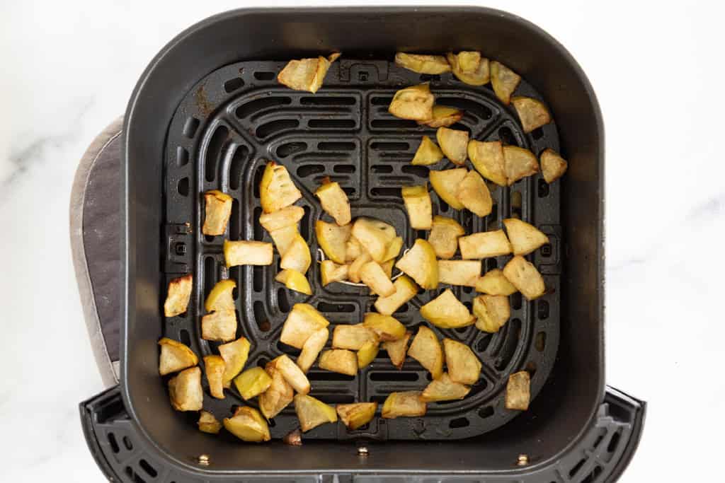 Air fryer apples in air fryer basket after cooking.