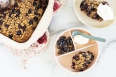 Blueberry baked oatmeal on two plates and in pan.