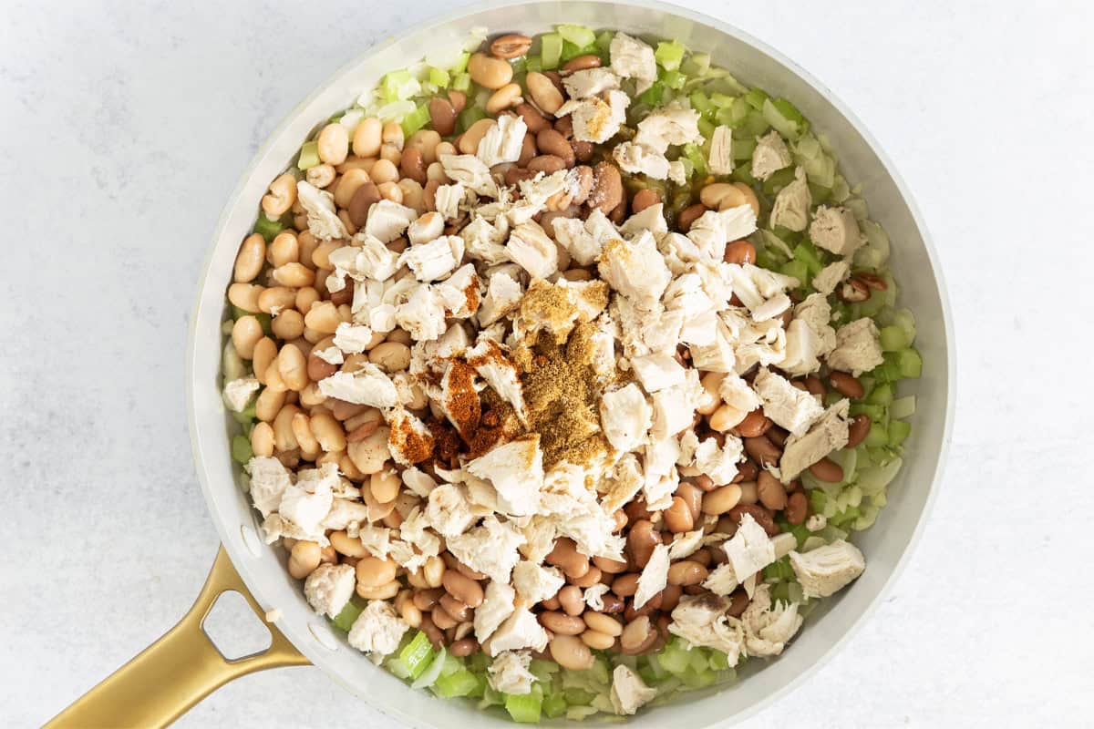 Veggies and turkey in pan for white turkey chili.