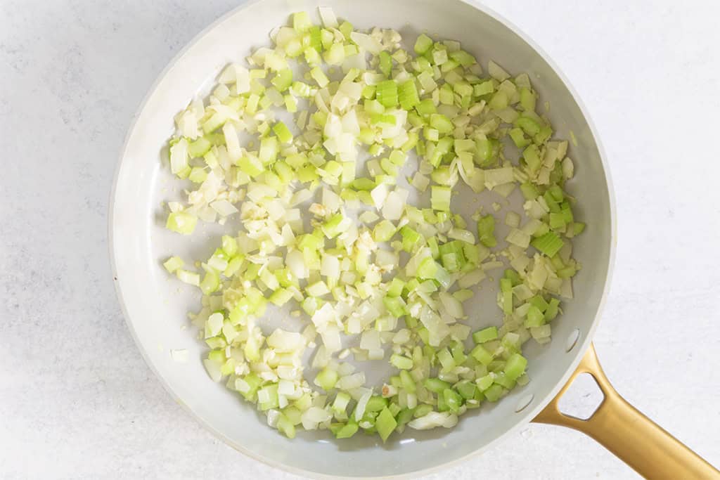 Onion and celery in pan for white turkey chili.