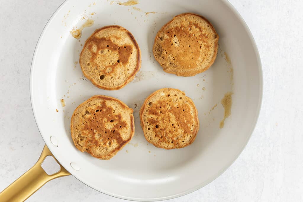 cooked gingerbread pancakes in pan on stove.