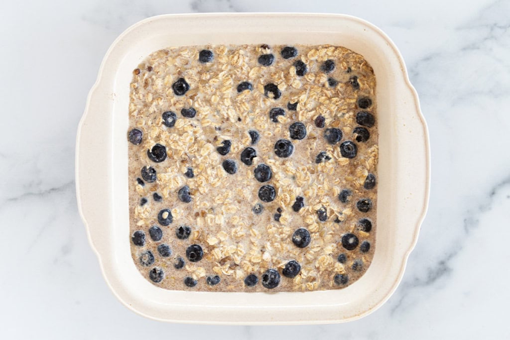 Blueberry baked oatmeal in pan before baking.