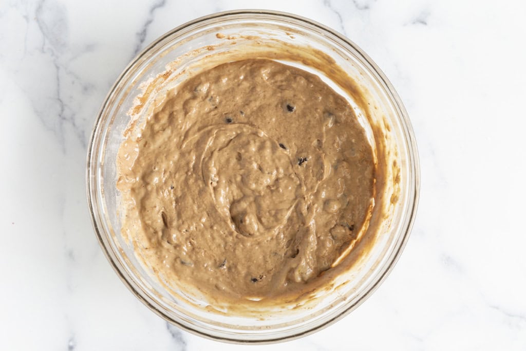 Batter for chocolate muffins in glass bowl.