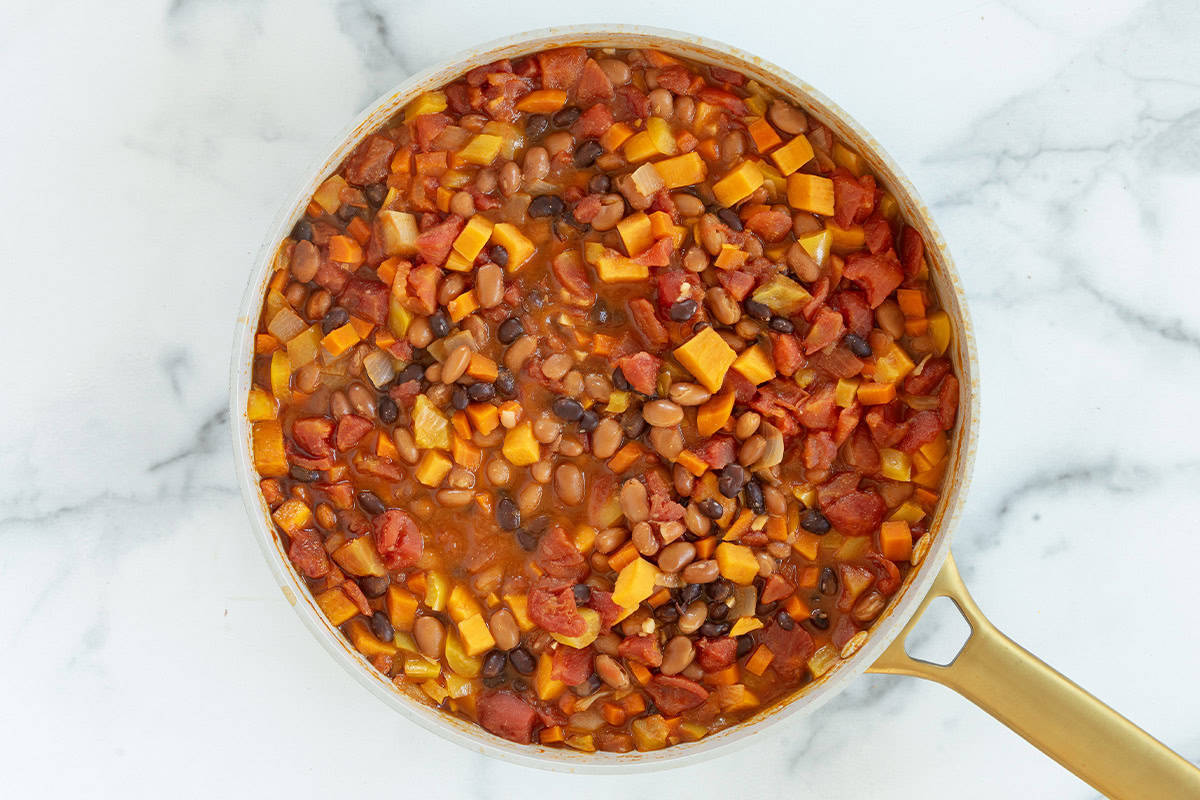 Veggies with broth in pan for veggie chili.