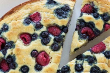 Berry breakfast cake with slice cut out.