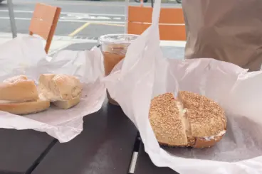 Bagels on parchment paper on outside table.