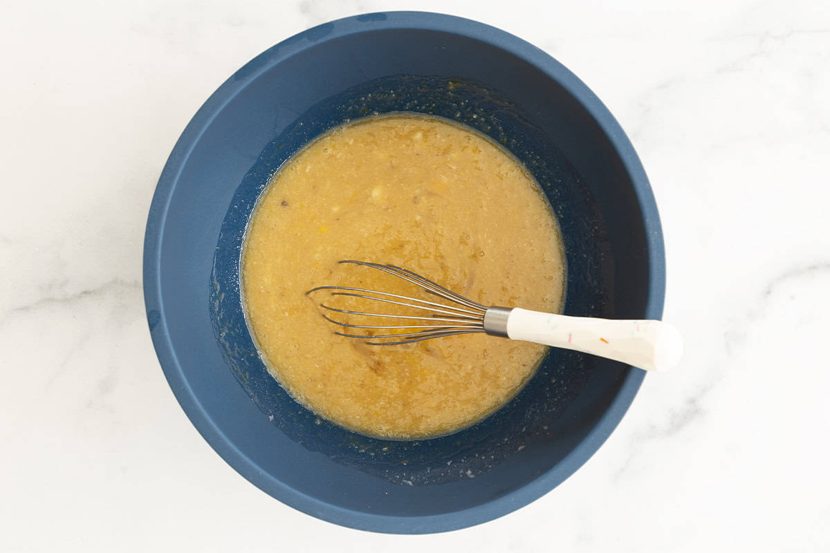 Wet ingredients for chocolate banana muffins in blue bowl. 