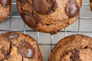 Chocolate peanut butter muffins on cooling rack.