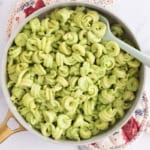 Pasta with pea sauce in pan with spoon.