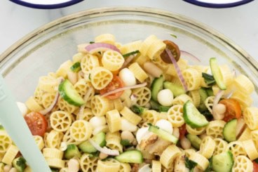 Pasta salad with chicken in three bowls.