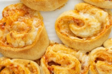 Pizza pinwheels after baking on baking sheet.