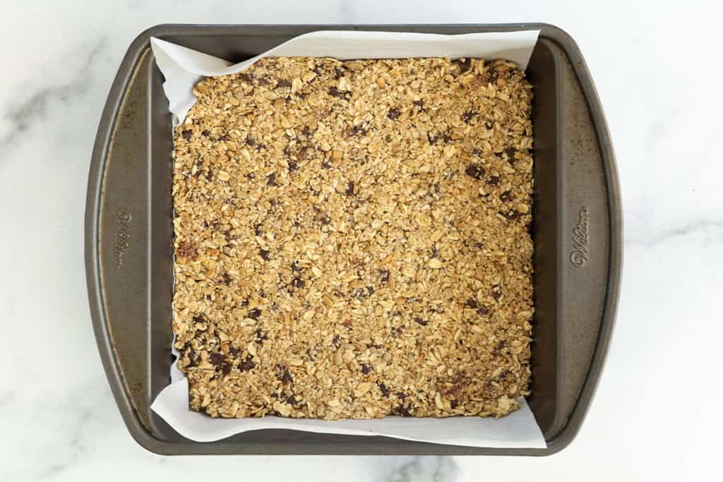 Chewy granola bars in baking pan.