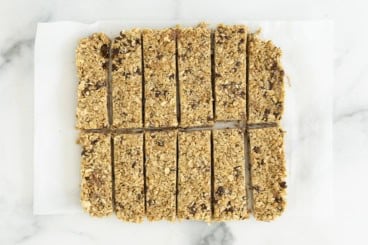 Chewy granola bars on parchment paper.