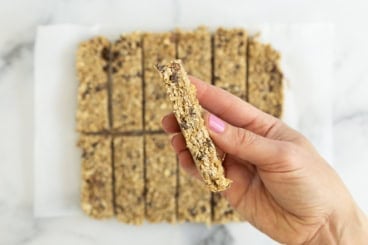 Hand holding chewy granola bar.