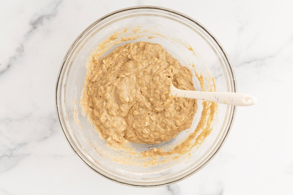 Batter for oatmeal cookies in glass bowl.