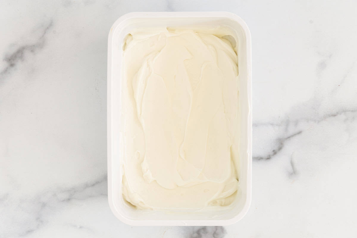 Greek frozen yogurt in white rectangle container.