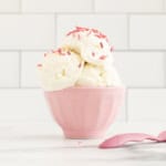 Greek Frozen yogurt in pink bowl with sprinkles.