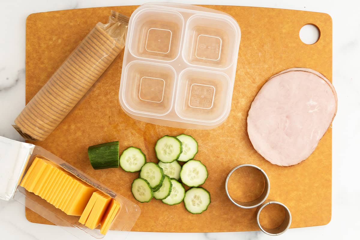 Making a homemade lunchable on parchment paper.