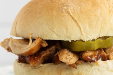 Instant pot bbq chicken sandwich on white plate.