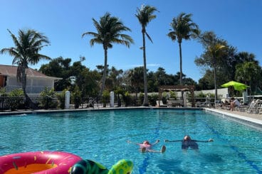 two kids floating in pool.