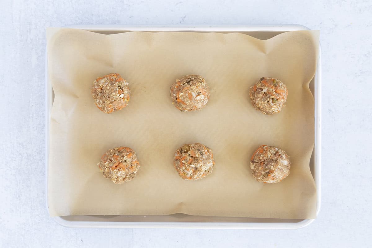 balls of healthy oatmeal cookie batter on parchment paper.