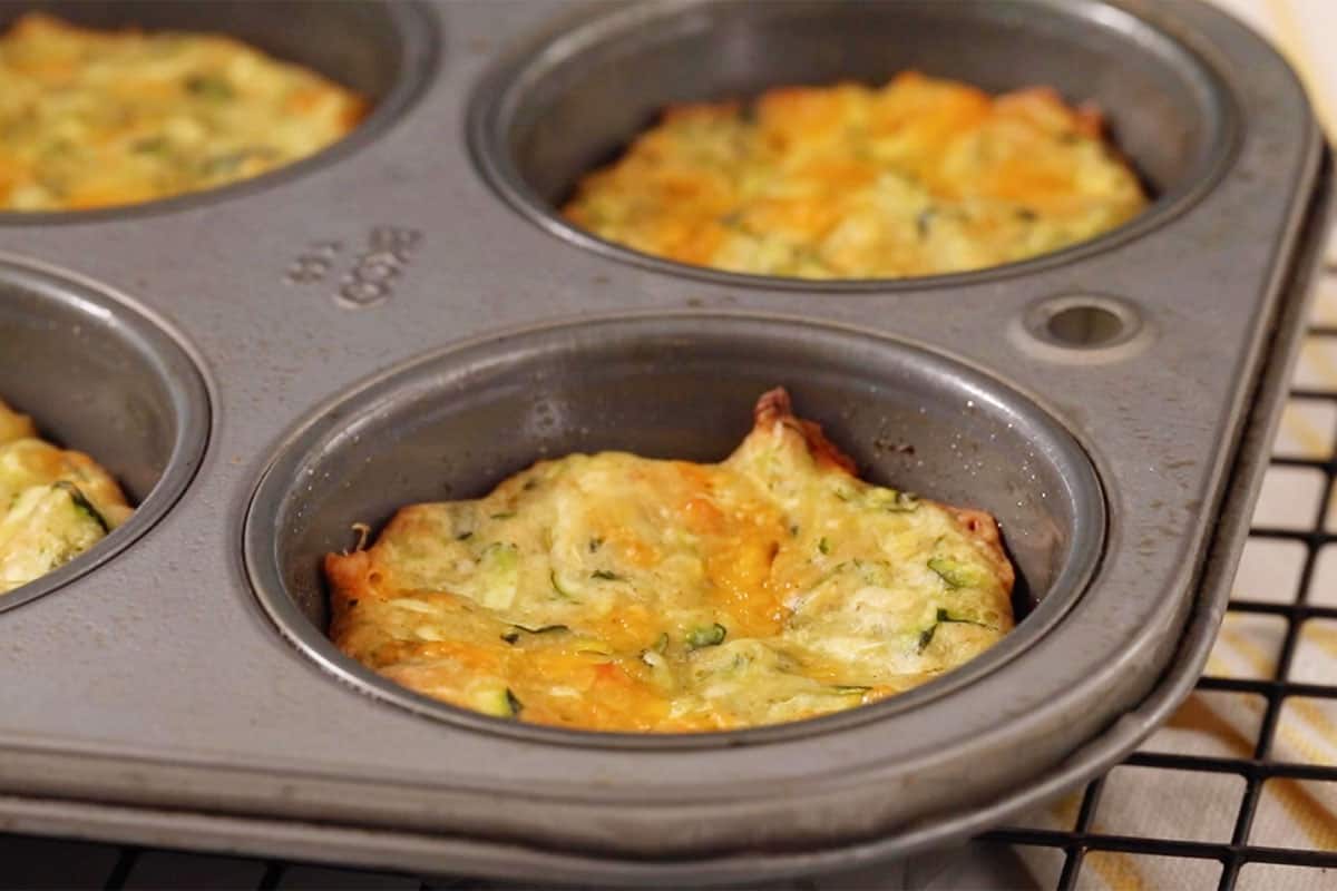 baked zucchini fritters in muffin pan.