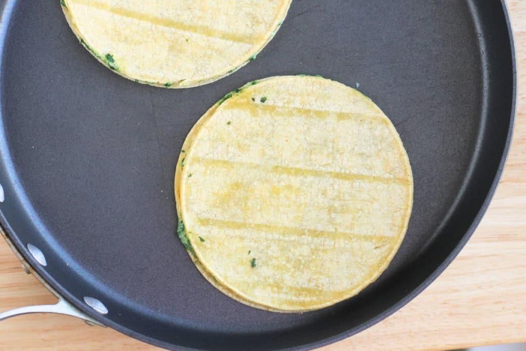 Spinach quesadillas in frying pan.