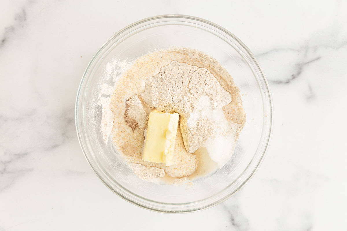 Ingredients for homemade crackers in glass bowl before stirring.