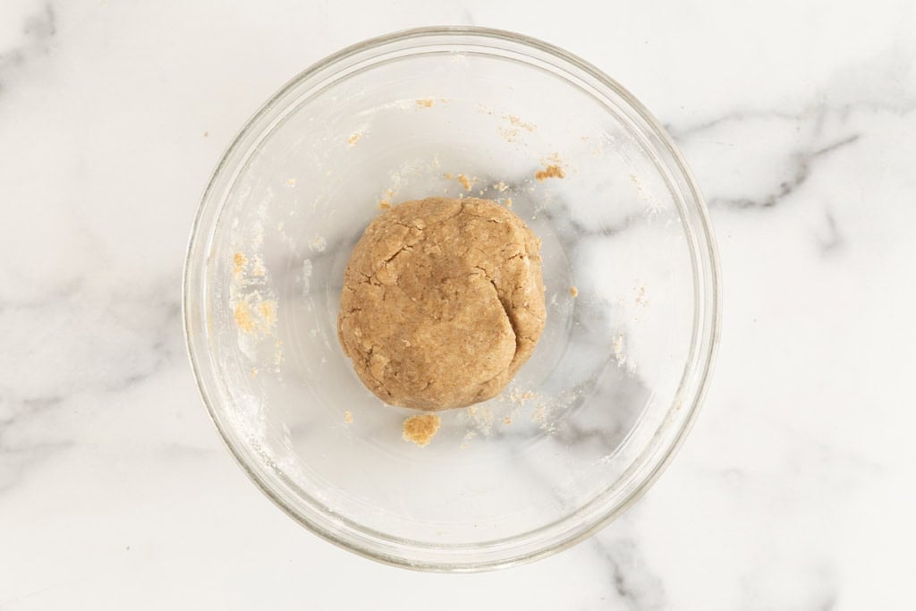 Dough for homemade crackers in glass bowl.