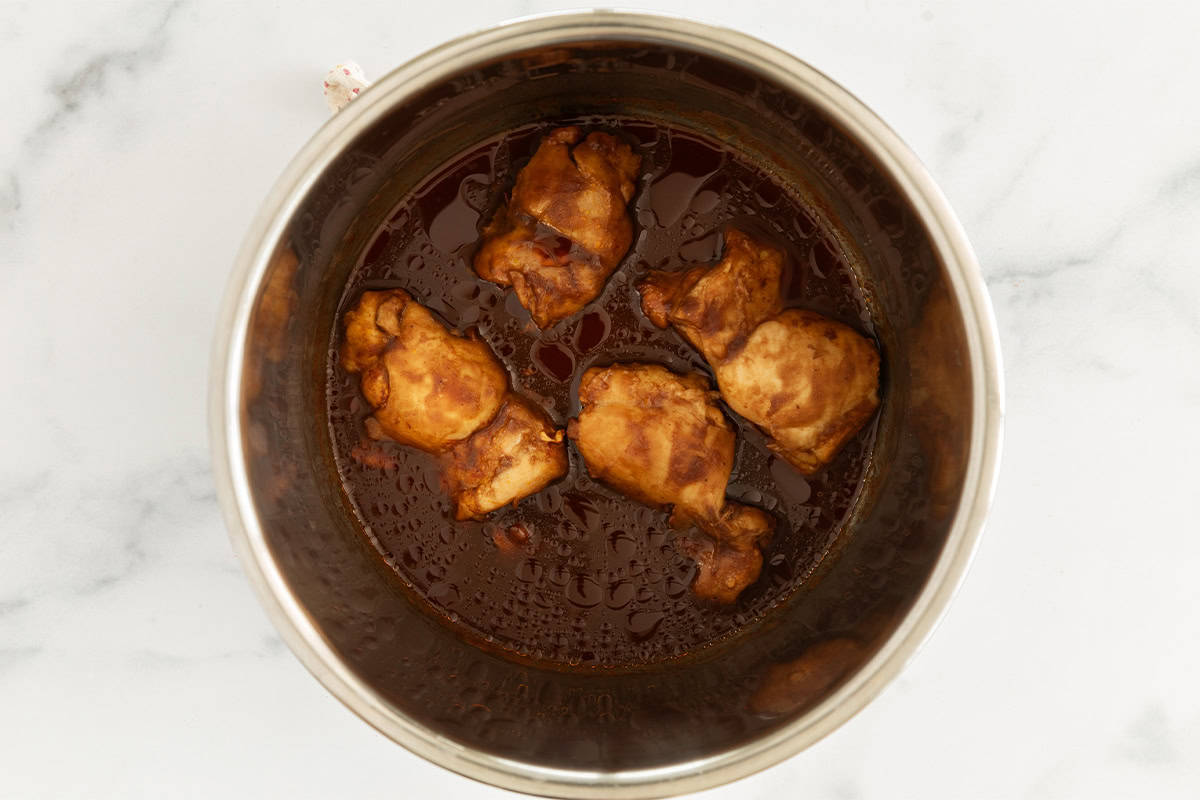 chicken and barbecue sauce in instant pot bowl.