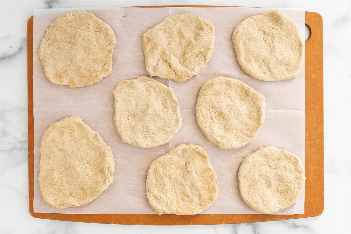 Dough circles on baking sheet for pizza pockets.